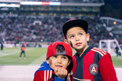Photo of two children during the Atlanta United game located at Bobby Dodd Stadium in Atlanta, Georgia.